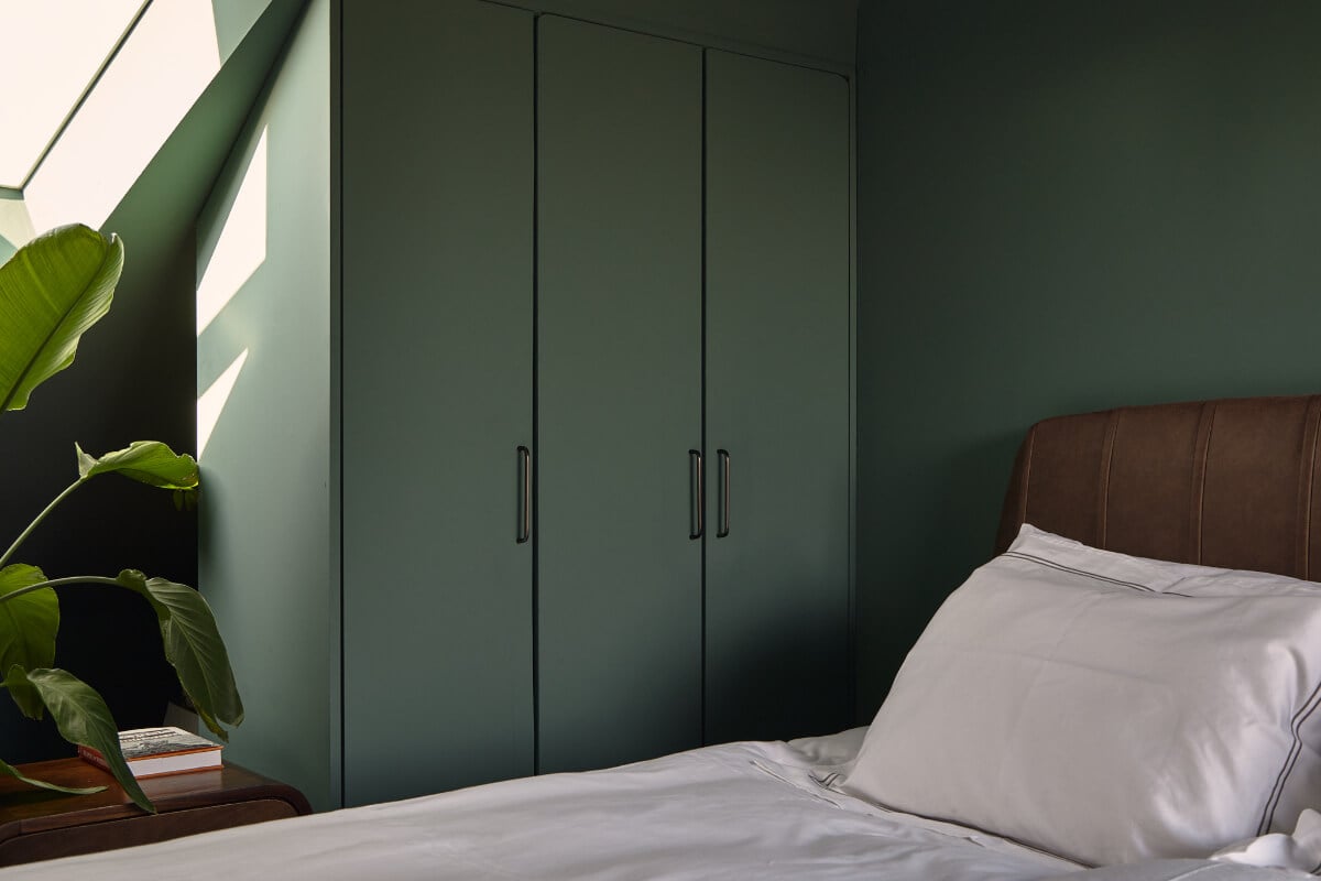 Moody Tones in a Restored and Extended Victorian Home in London 19 built-in wardrobes under slanted ceiling