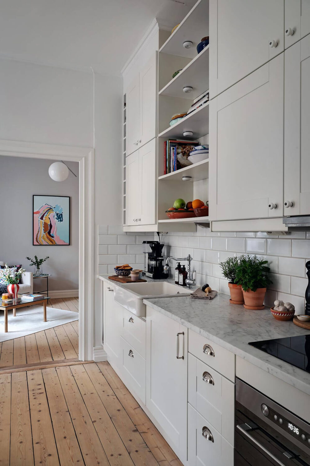 Classic Elements in a Charming Swedish Studio Apartment 13 classic light colored kitchen marble countertop wooden floorboards
