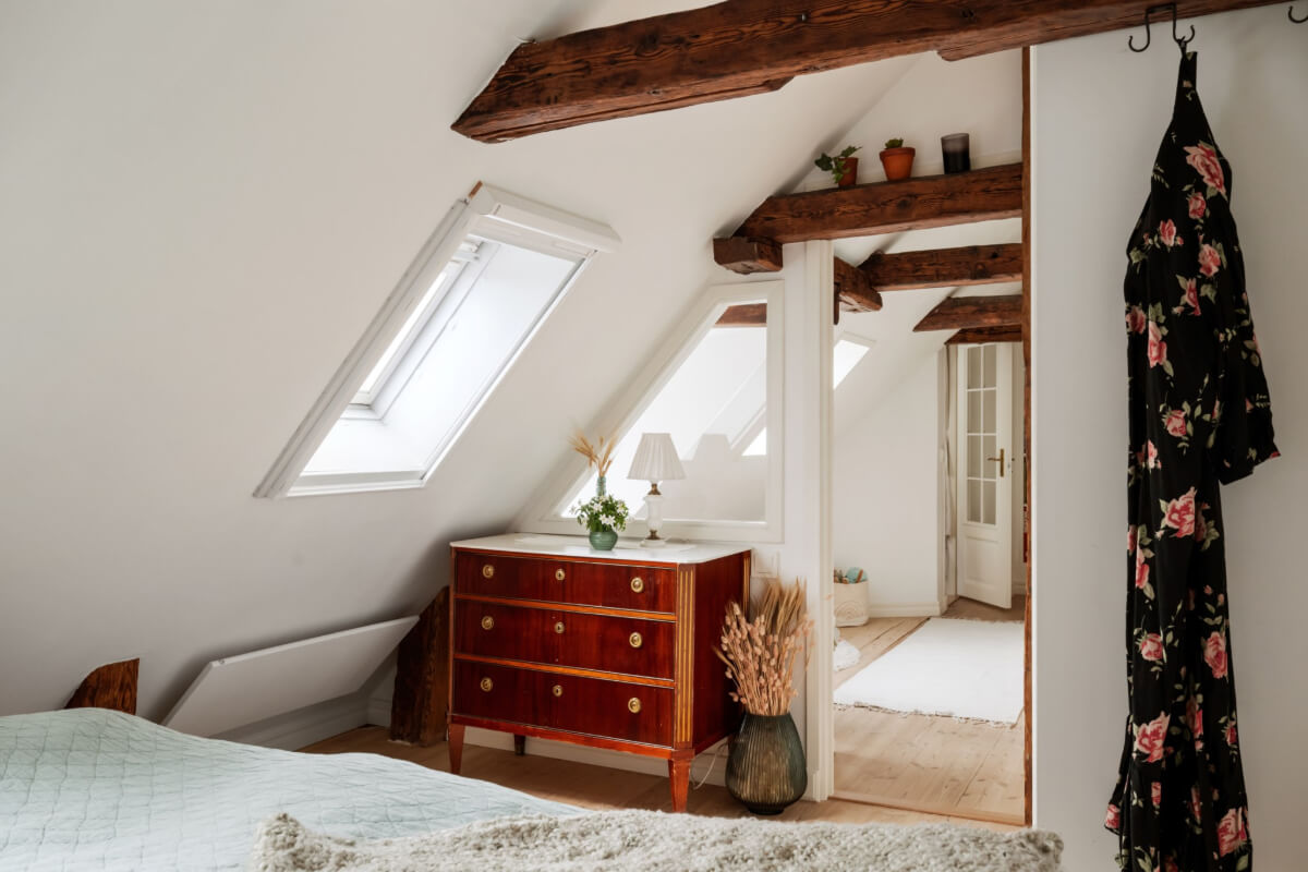 A Charming Attic Apartment in Stockholm's Gamla Stan 16 cozy bedroom exposed wooden beams