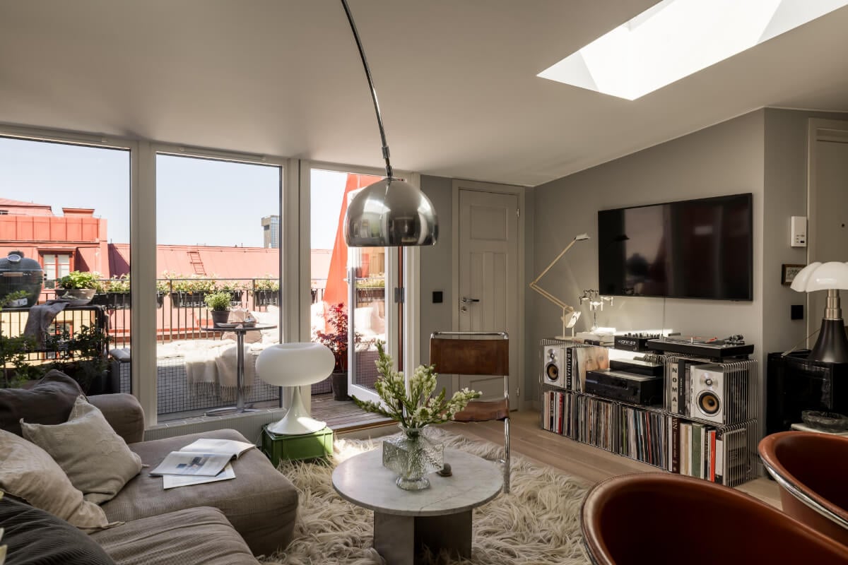 A Small, Cozy Attic Apartment with a Large Terrace 3 cozy gray living room with large balcony