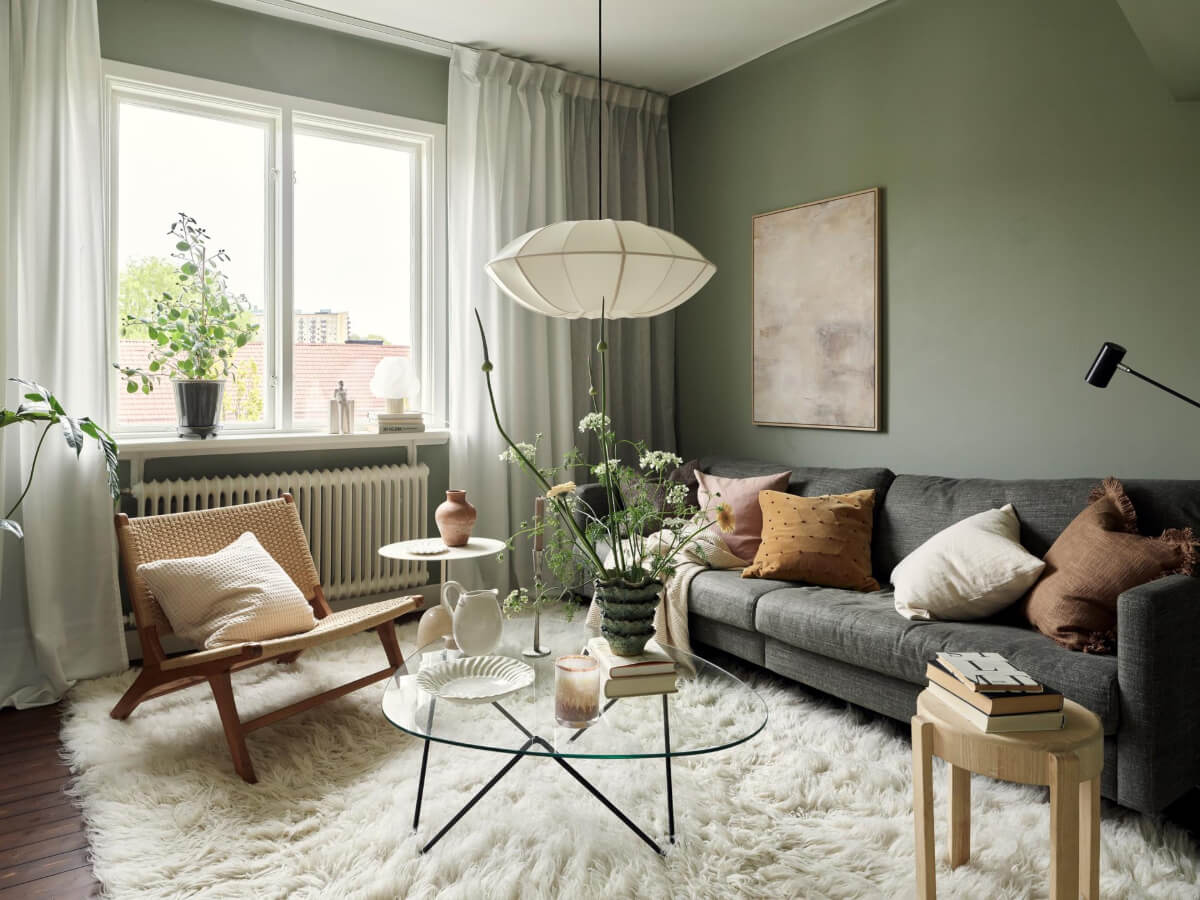 A Harmonious Color Palette in a Swedish Duplex Apartment 10 cozy green living room large rug
