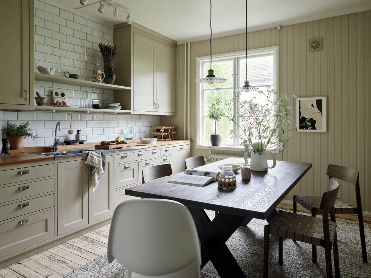 An Apartment with Original Details and a Stunning Period-Style Bathroom 2 cozy kitchen large wooden table paneled walls