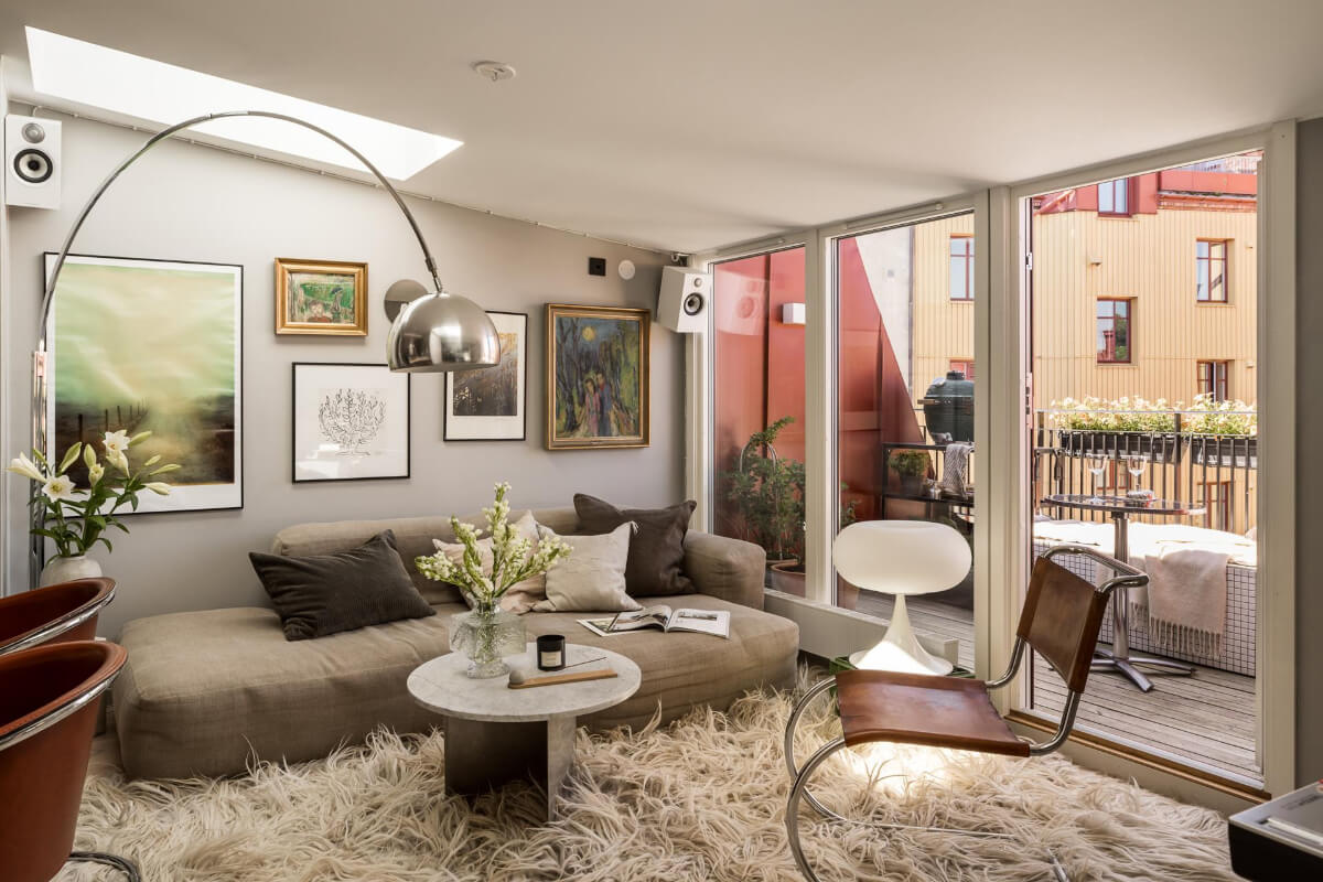 A Small, Cozy Attic Apartment with a Large Terrace 2 cozy scandi living room large rug skylights