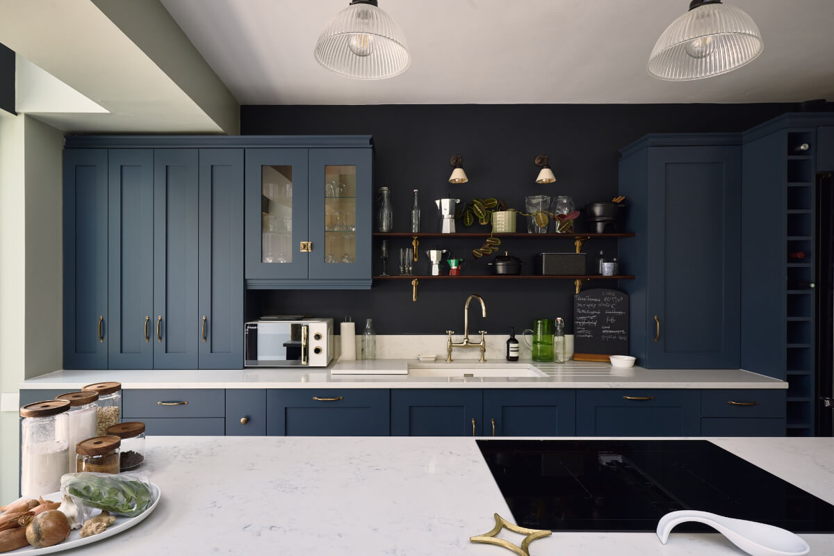 Moody Tones in a Restored and Extended Victorian Home in London 2 dark blue kitchen brass handles shelves