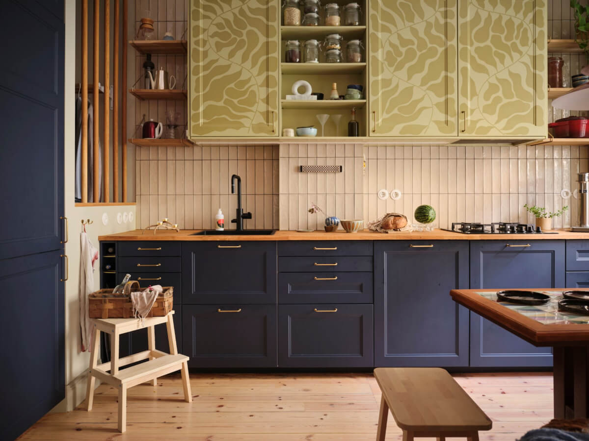 A Fantastic Small Art Nouveau Apartment in Stockholm 2 dark blue kitchen cabinets beige tiles patterned green upper cabinets nordroom