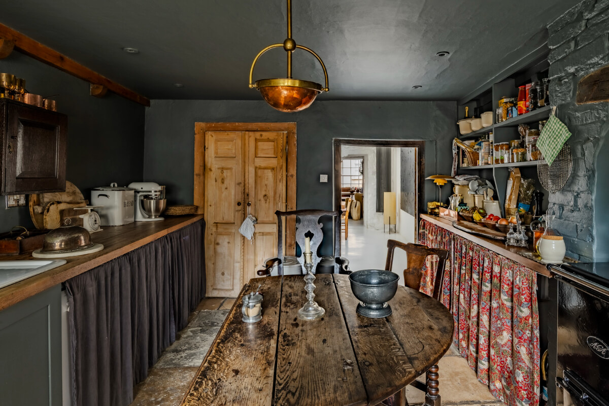 White-Washed Walls and Rustic Elements in a 17th Century Townhouse 14 dark blue kitchen rustic wooden table open shelves