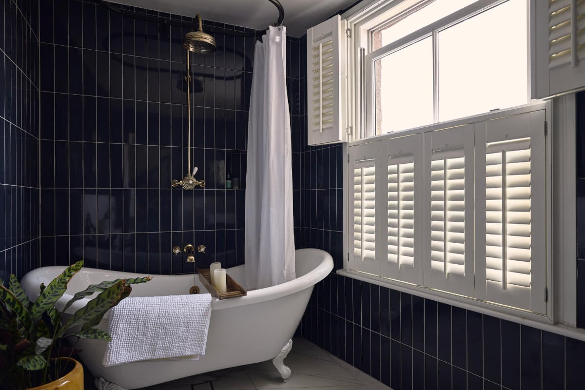Moody Tones in a Restored and Extended Victorian Home in London 24 dark blue tiles bathroom freestanding clawfoot bath