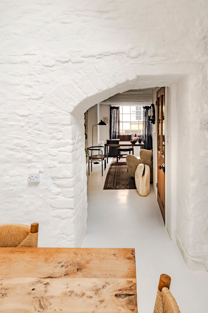 White-Washed Walls and Rustic Elements in a 17th Century Townhouse 12 dining room arched entry
