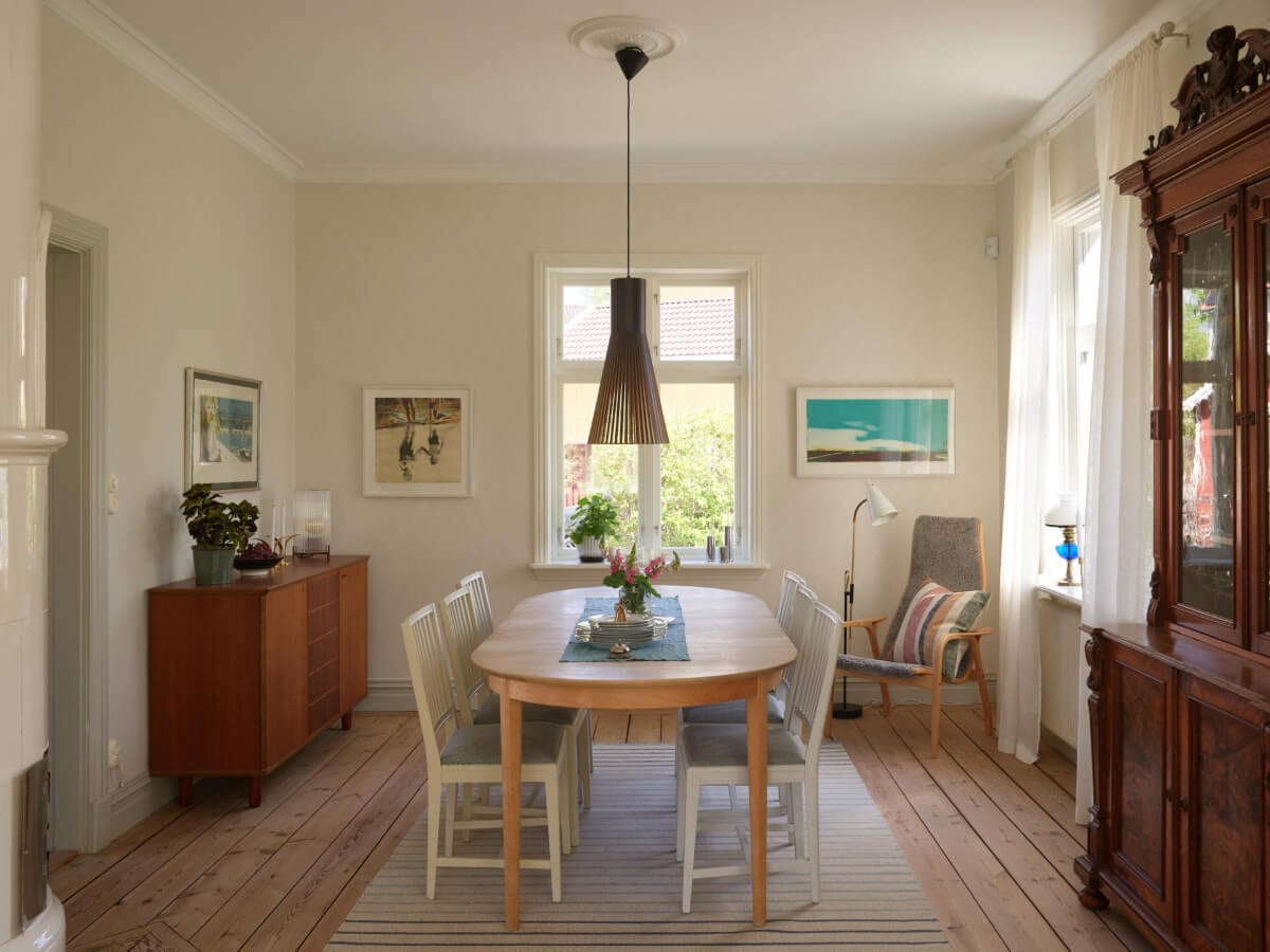 Light-Filled Rooms and Wallpapers in a Swedish Country House 7 dining room fireplace wooden floor