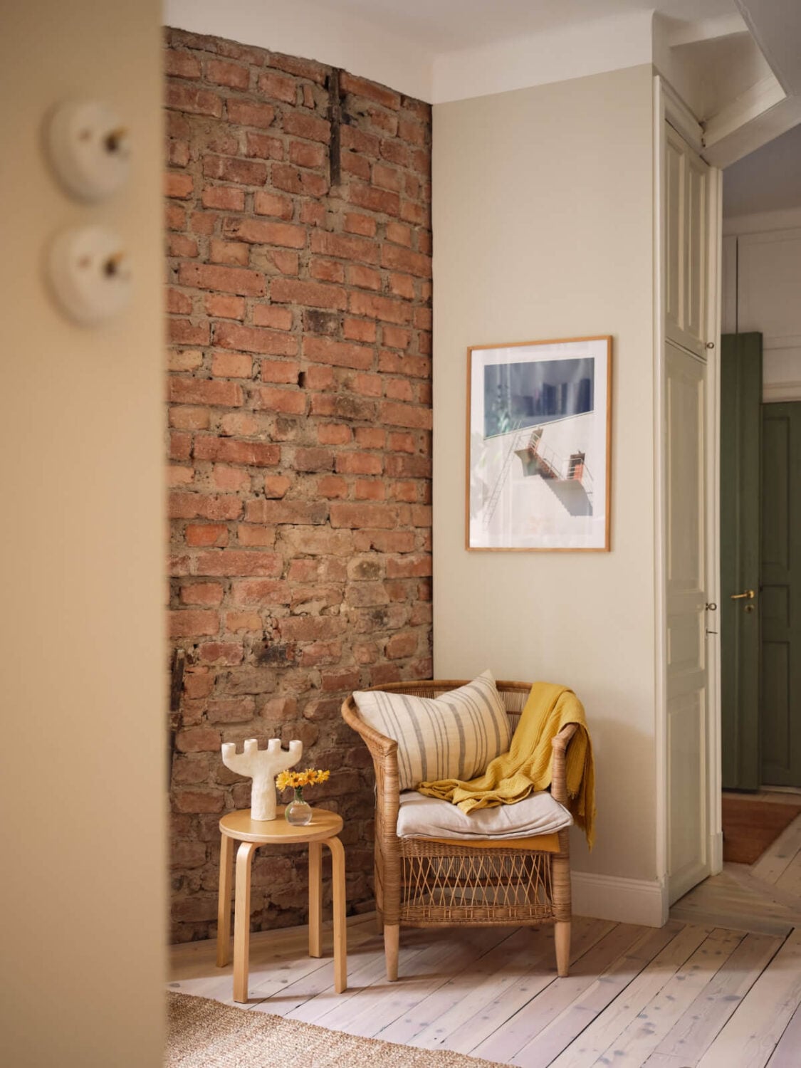 A Cozy, Tiny Apartment with a Golden Yellow Bedroom 6 exposed brick wall living room