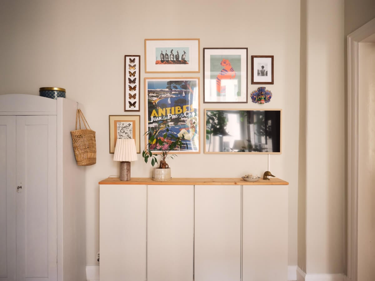 A Cozy, Tiny Apartment with a Golden Yellow Bedroom 4 floating cabinets gallery wall