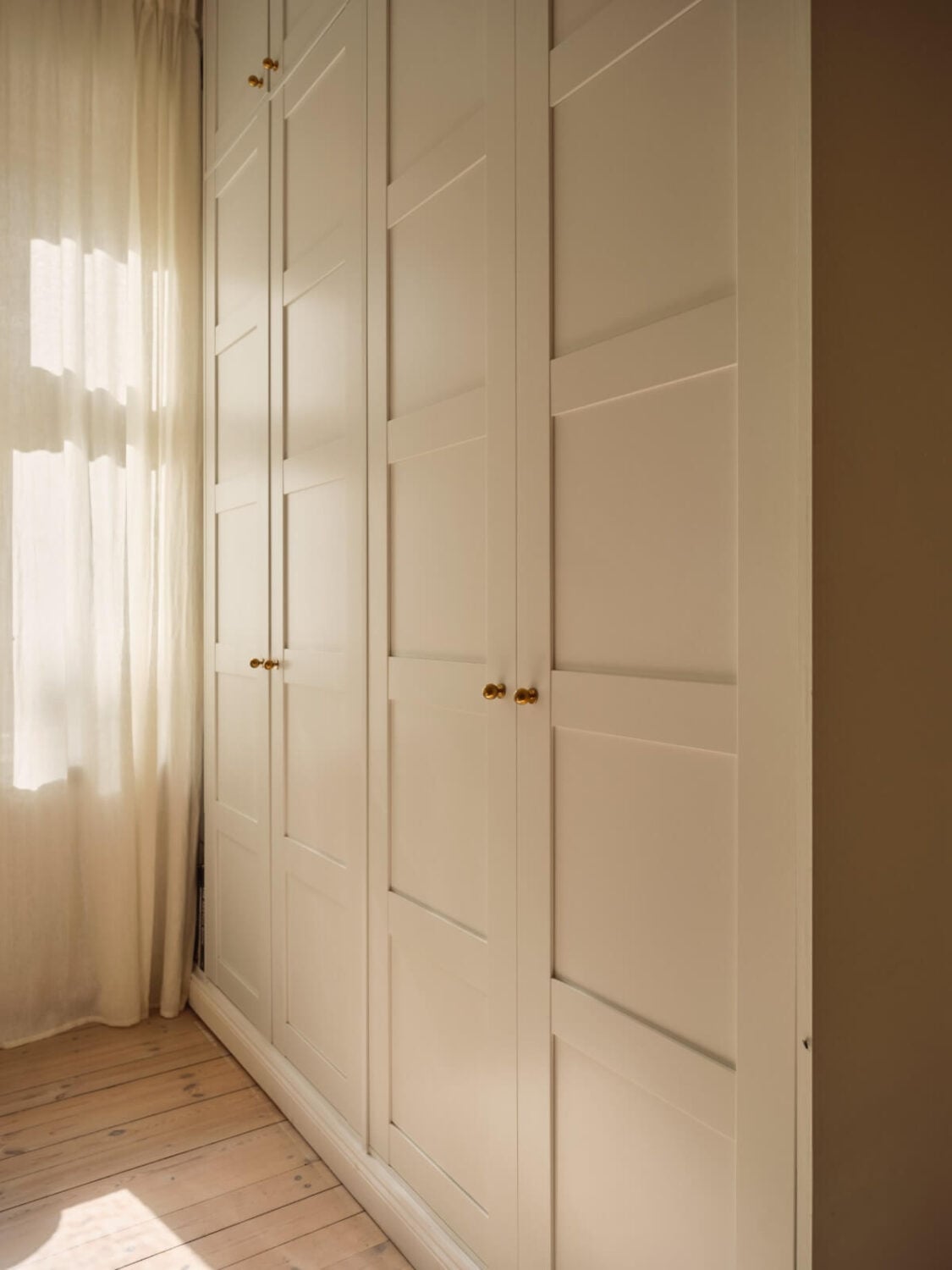 A Cozy, Tiny Apartment with a Golden Yellow Bedroom 15 floor-to-ceiling bedroom wardrobes