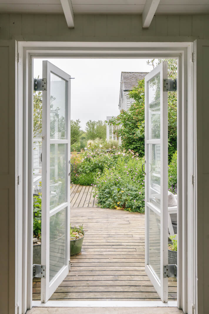A Bright New England-Style Home with a Lush Garden 11 garden doors