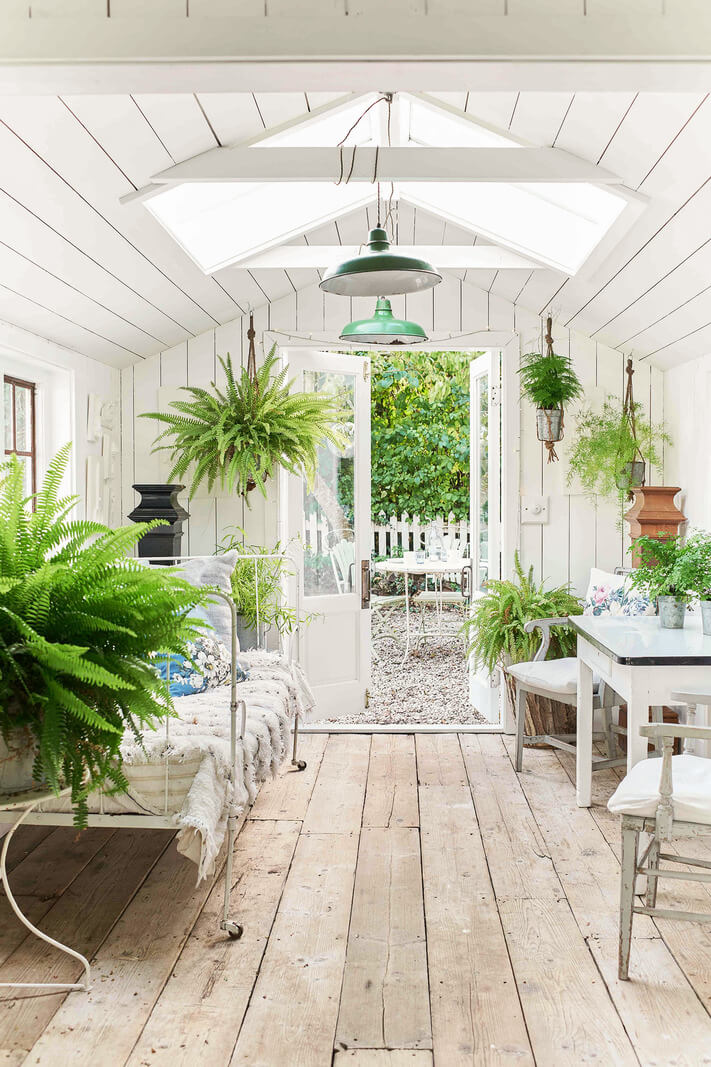 A Bright New England-Style Home with a Lush Garden 22 garden room timber floorboards