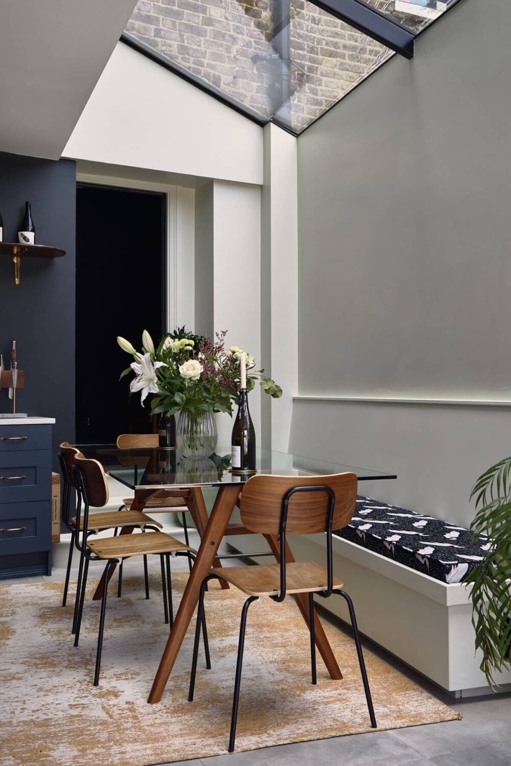 Moody Tones in a Restored and Extended Victorian Home in London 7 glass dining table built-in bench