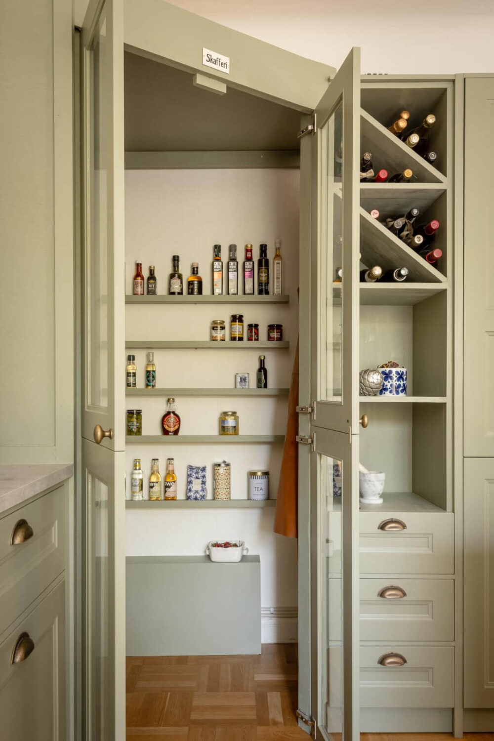 A Cozy Swedish Apartment with a Walk-In Pantry in the Sage Green Kitchen 17 glass pantry doors