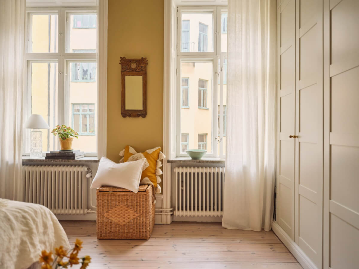 A Cozy, Tiny Apartment with a Golden Yellow Bedroom 14 golden yellow bedroom built-in wardrobes