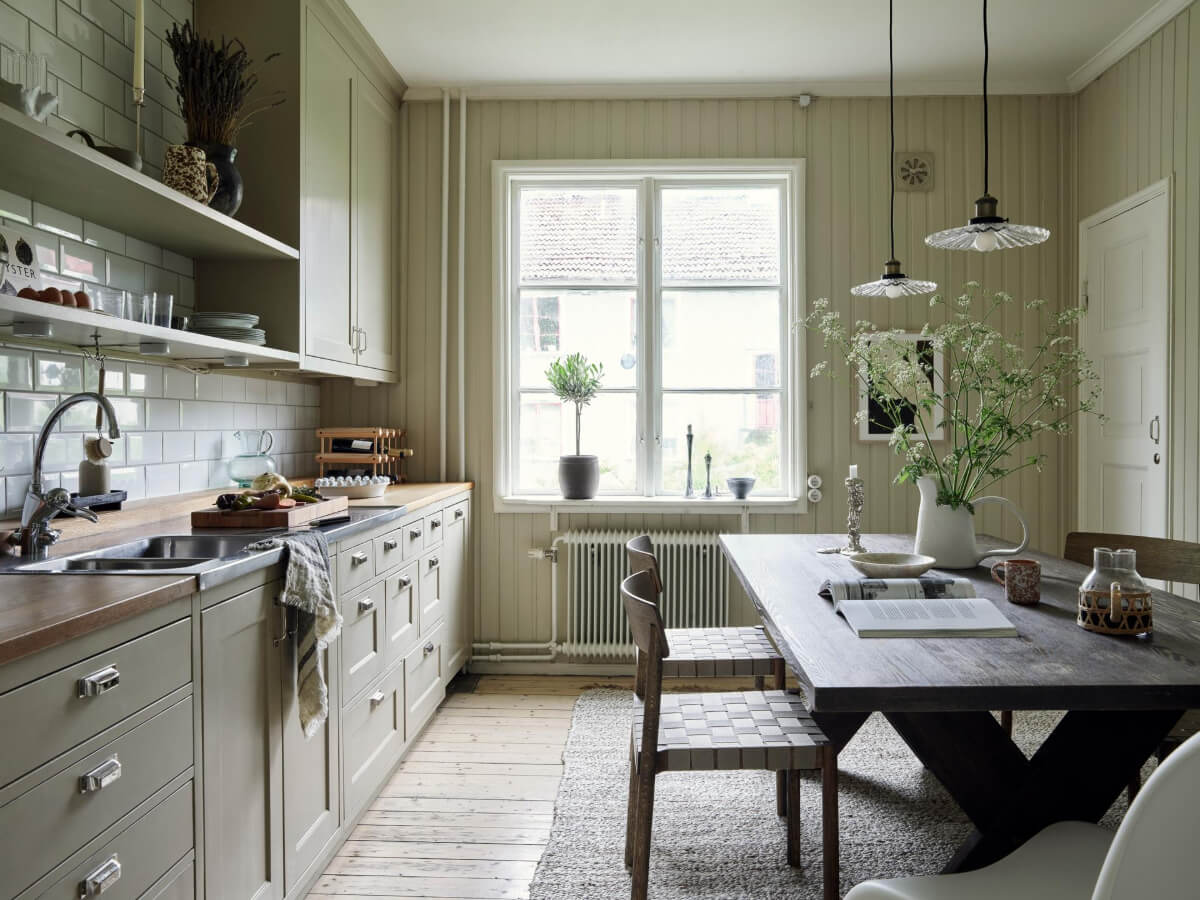 The Color Trends for 2026: A Return to Nature, Balance, and Grounding 15 gray-green kitchen white subway tiles shelves wooden dining table with rug