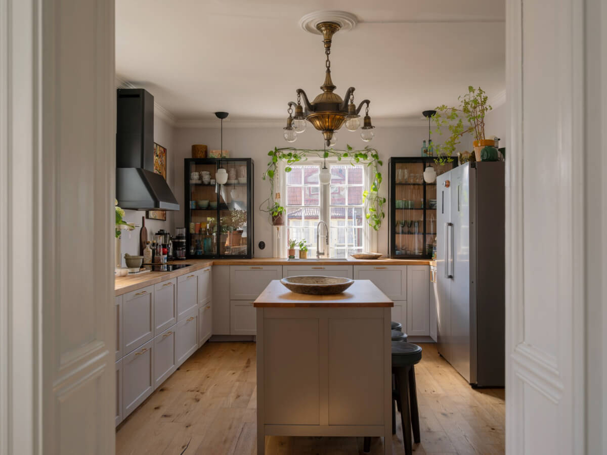 An Early 20th-Century Family Home Decorated with Color and Art 11 gray kitchen with island large window