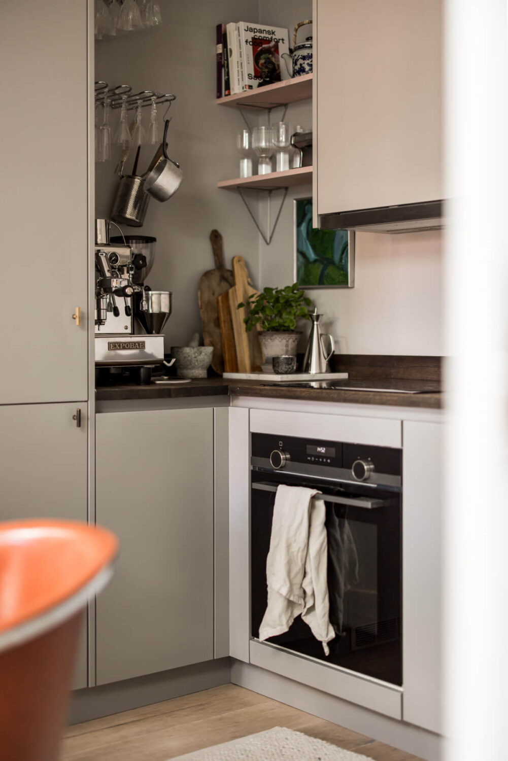 A Small, Cozy Attic Apartment with a Large Terrace 8 gray kitchen with wooden shelves