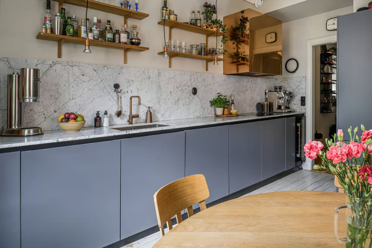 A Spacious One-Bedroom Apartment in Gothenburg 6 gray modern kvik kitchen carrara marble countertop shelves nordroom