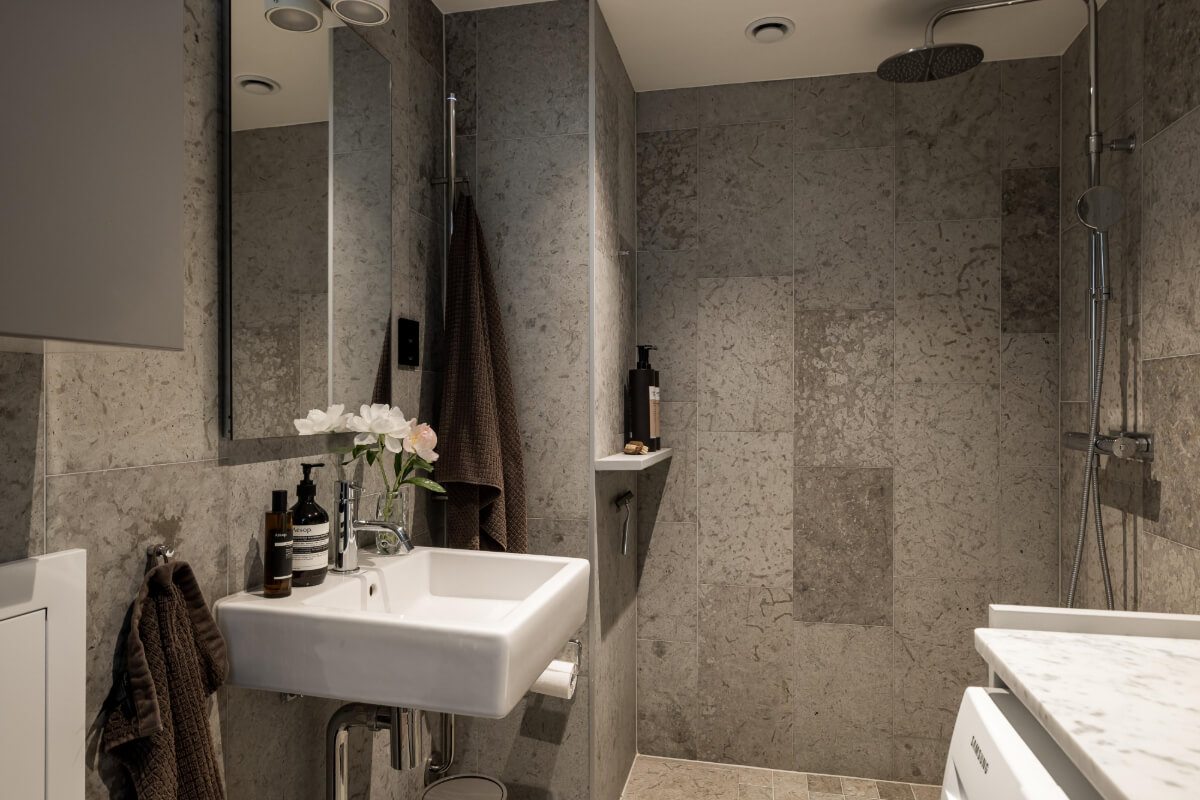 A Small, Cozy Attic Apartment with a Large Terrace 13 gray tiled bathroom