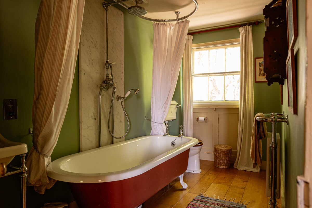 A Carefully Restored Georgian Townhouse in East London 23 green bathroom terracotta pink bath wooden floor