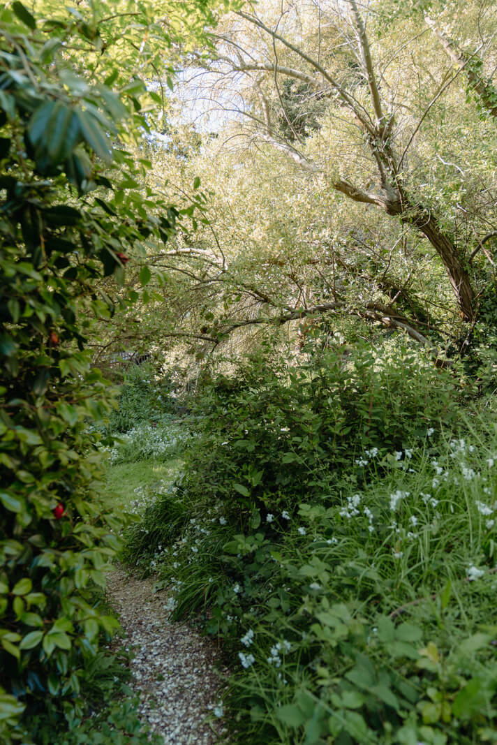 Grand, Light-Filled Spaces in a Gothic-Style English Coastal Home 29 green garden path