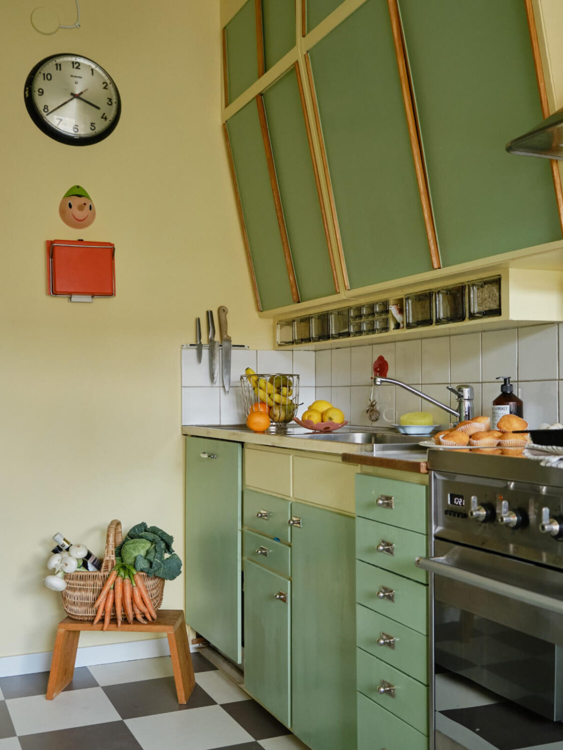 A Colorful 1940s Apartment with Original Elements 16 green kitchen slanted upper cabinets checkerboard floor