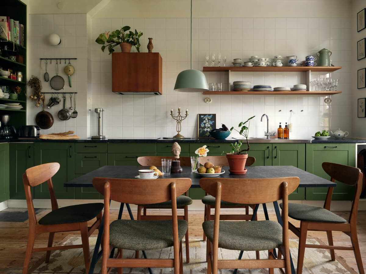 An Art Nouveau Apartment with a Deep Green Kitchen 2 green kitchen white backsplash tiles wooden shelves