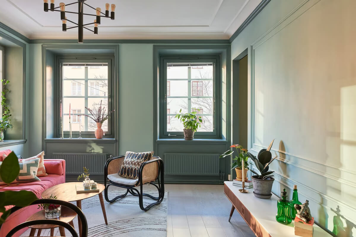 A Green Swedish Corner Apartment with an Open Floor Plan 10 green living room large windows A Green Swedish Corner Apartment with an Open Floor Plan