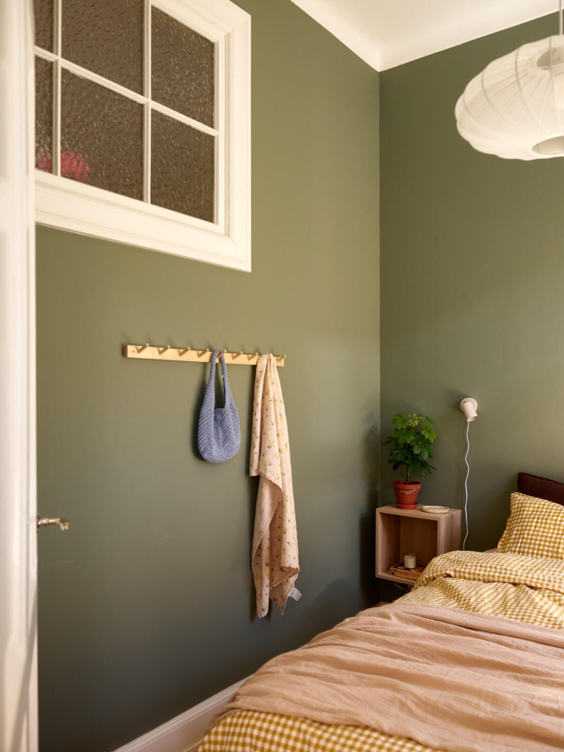 A Light-Filled Stockholm Apartment with Bright Color Pops 14 green walls bedroom
