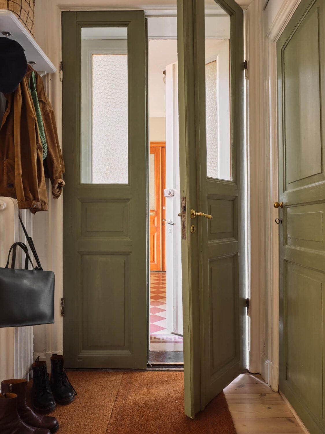 A Cozy, Tiny Apartment with a Golden Yellow Bedroom 20 green wooden double front door A Cozy, Tiny Apartment with a Golden Yellow Bedroom