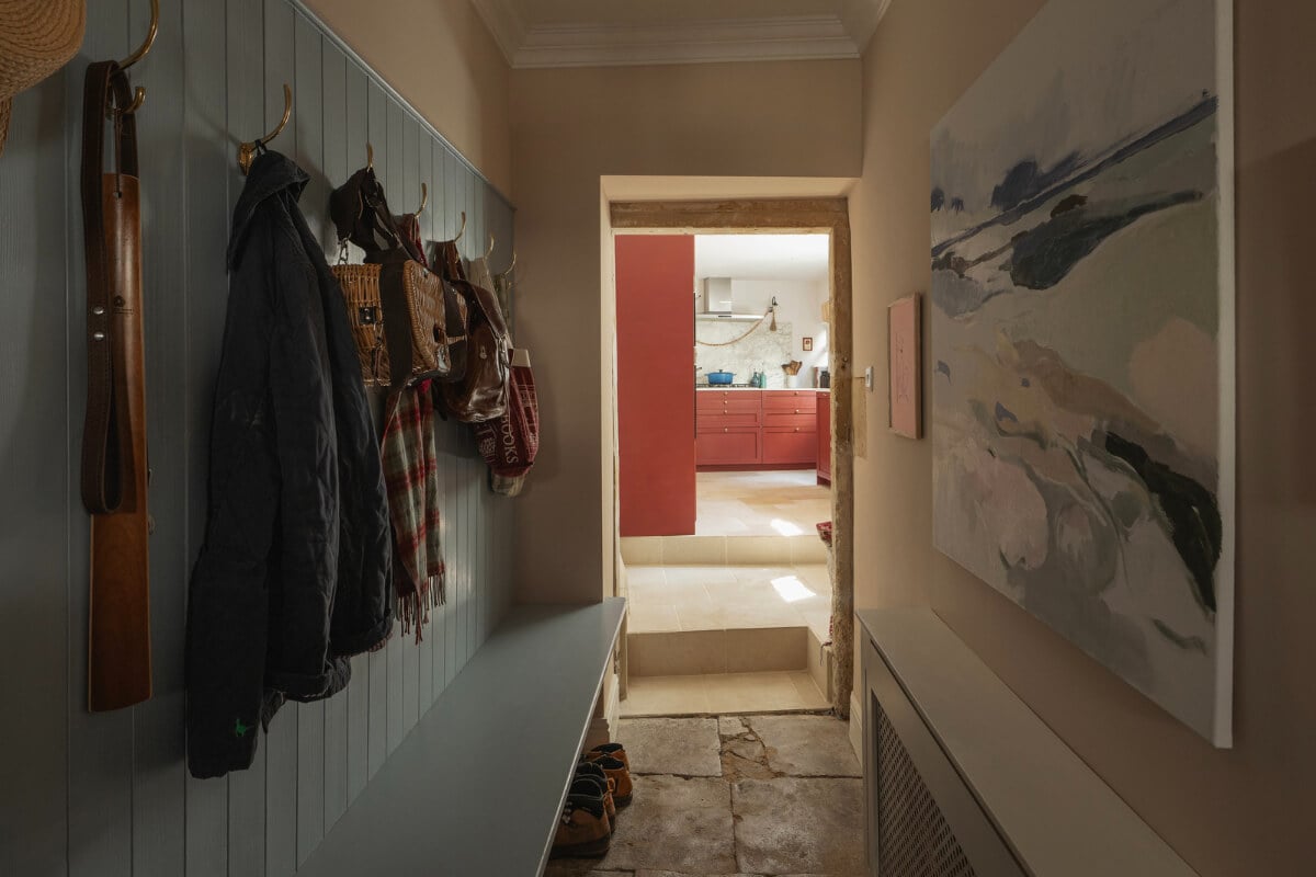 A Family Home with a Cheerful Color Palette in a Historic House 11 hall blue-painted paneling stone floor