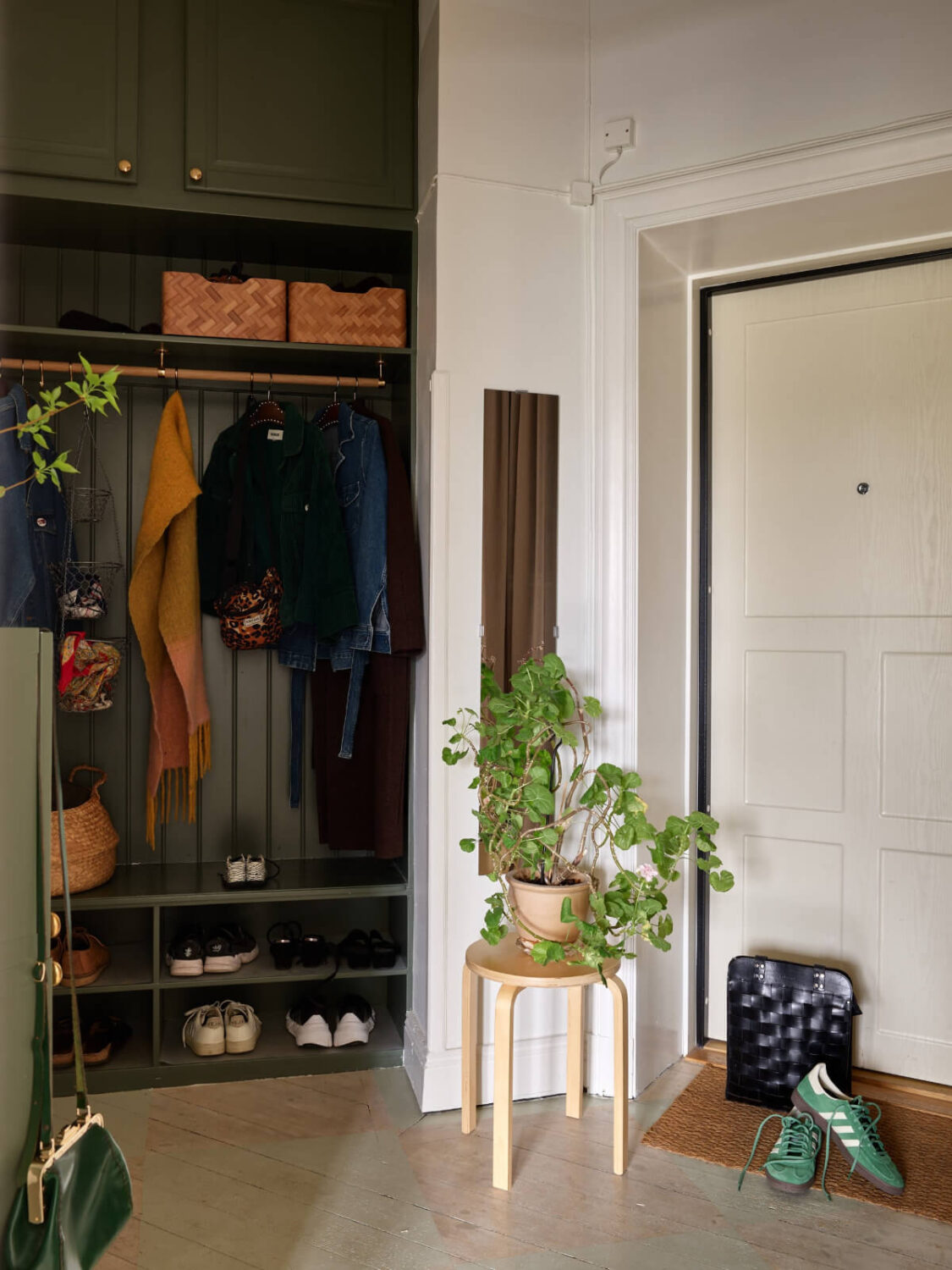A Beautifully Renovated Early 20th-Century Apartment 27 hall green built in cabinets A Beautifully Renovated Early 20th-Century Apartment