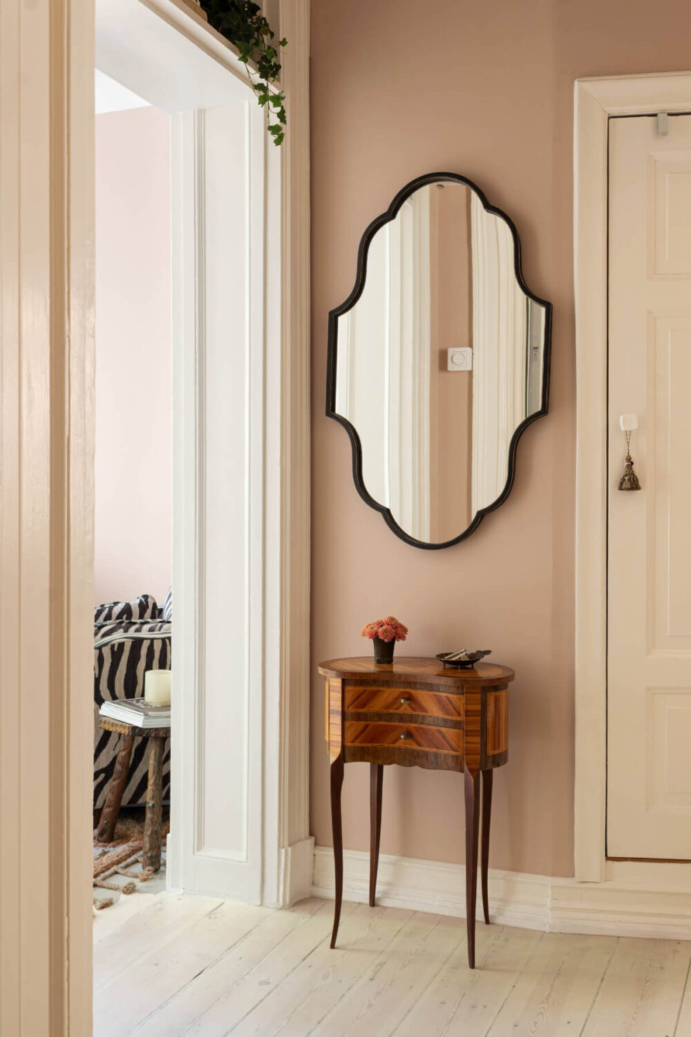 A Pink Studio Apartment with a Modern Black Kitchen 15 hall mirror A Pink Studio Apartment with a Modern Black Kitchen