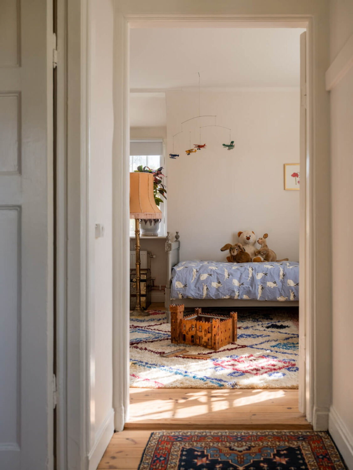 An Early 20th-Century Family Home Decorated with Color and Art 21 hall view into kids bedroom