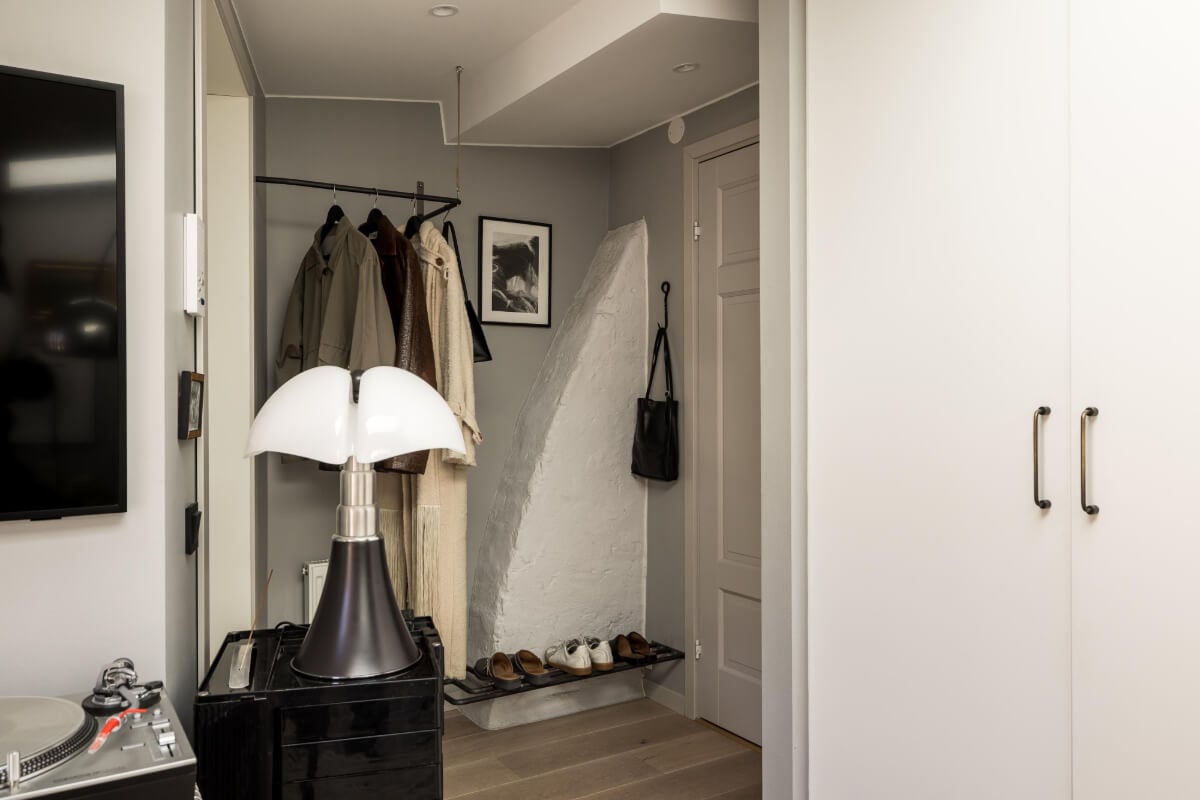 A Small, Cozy Attic Apartment with a Large Terrace 15 hall with coat rack and stone wall A Small, Cozy Attic Apartment with a Large Terrace