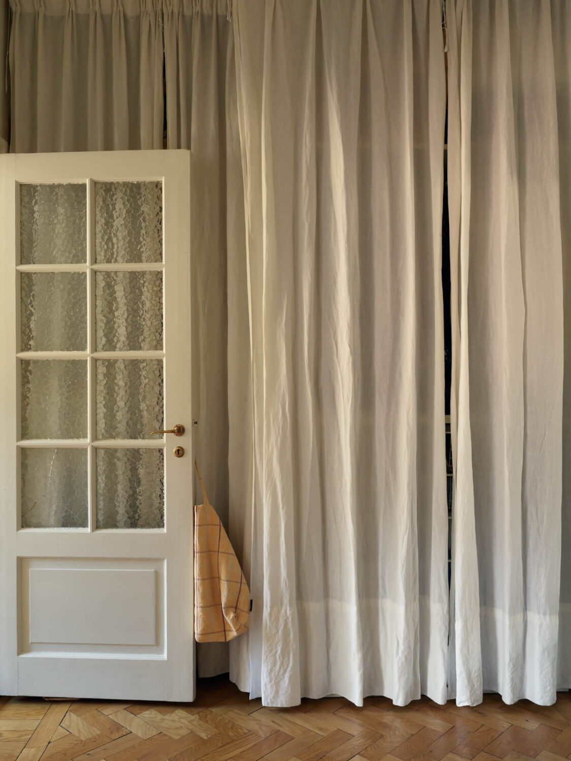 Warm Walls and Original Elements in a Swedish Studio Apartment 16 hall with storage behind curtains