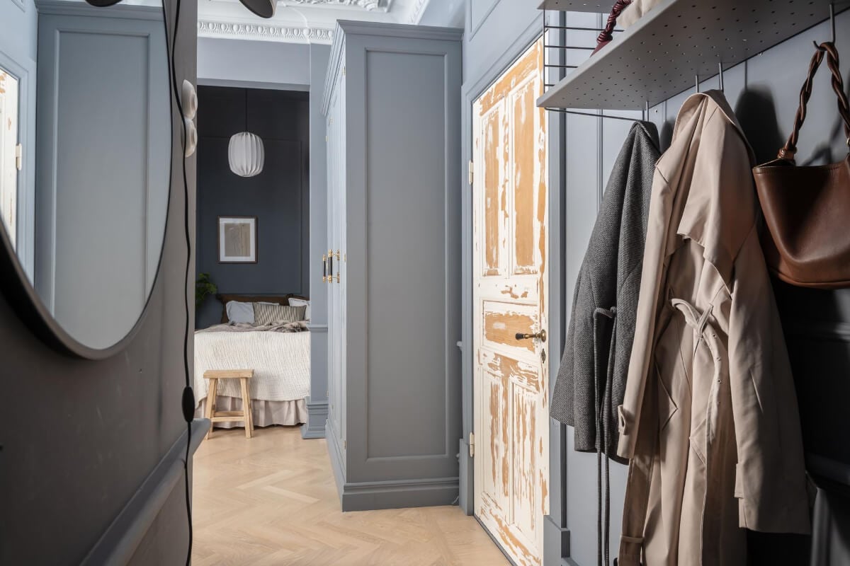 A Blue Studio Apartment with Unique Stucco and Site-Built Storage 19 hallway round mirror A Blue Studio Apartment with Unique Stucco and Site-Built Storage