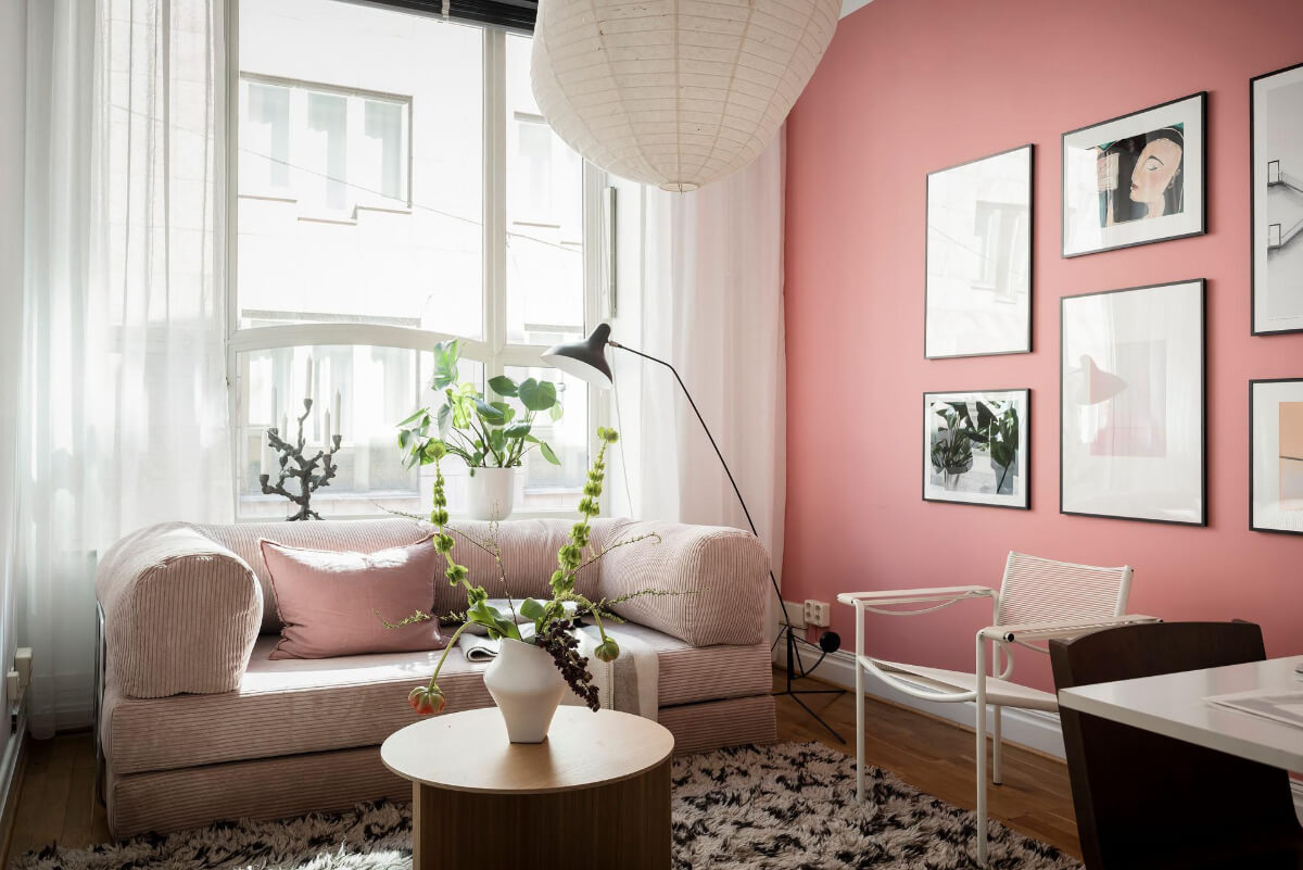 A Teal Green Living Room and Large Windows in a Swedish Apartment 20 home office with sofa and pink wall
