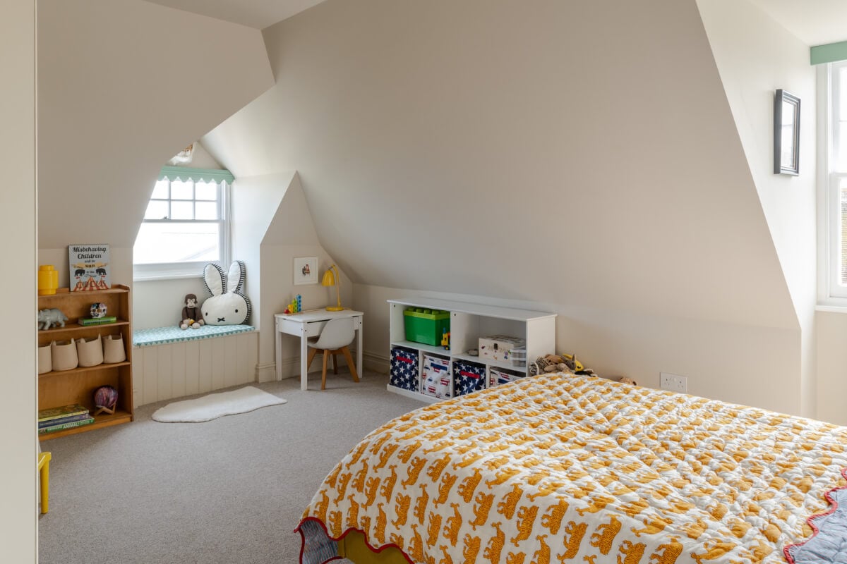 A Grand Edwardian Villa with a Yellow Kitchen and Coastal Views 27 kids bedroom window seat slanted ceilings