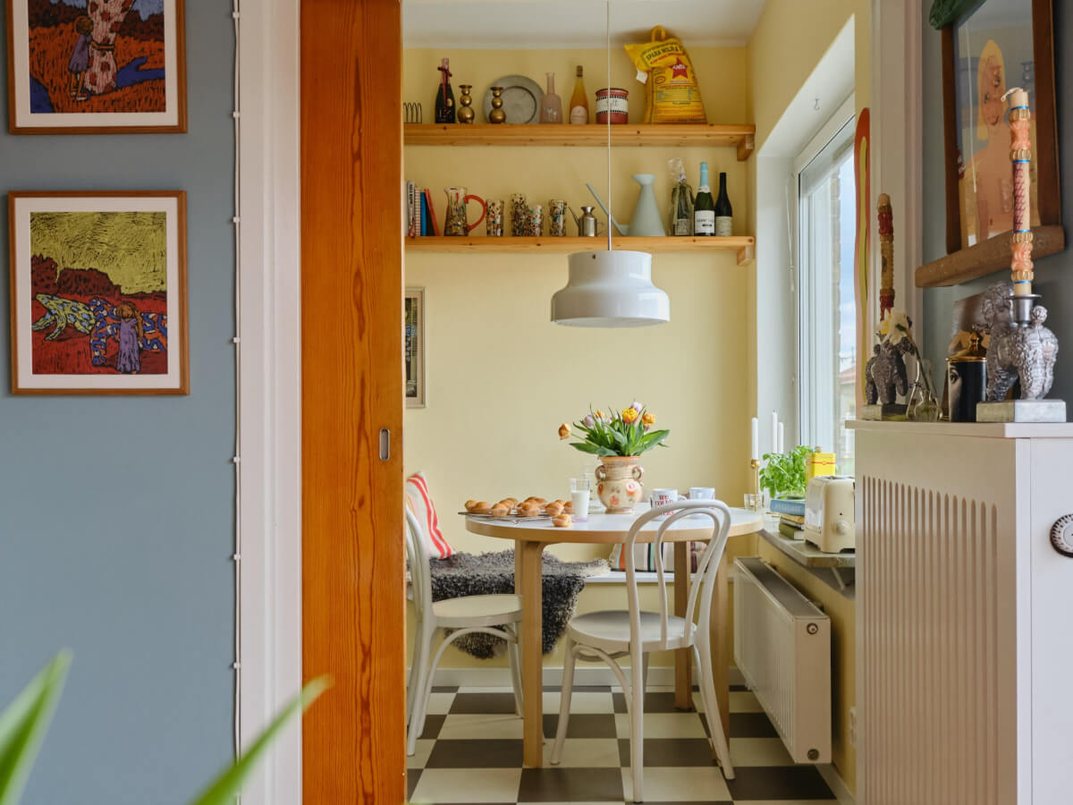 A Colorful 1940s Apartment with Original Elements 11 kitchen dining nook round table yellow walls