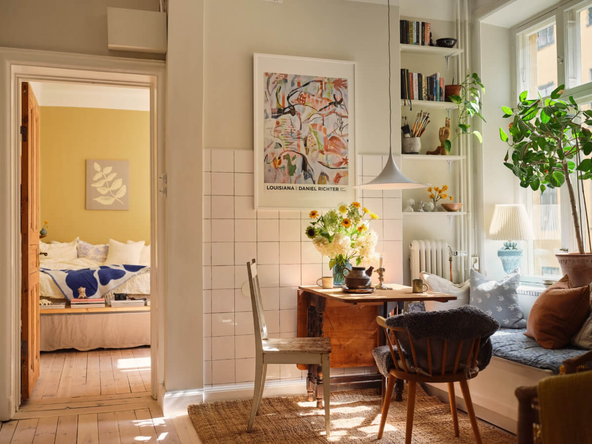 A Cozy, Tiny Apartment with a Golden Yellow Bedroom 2 kitchen dining space window seat shelves