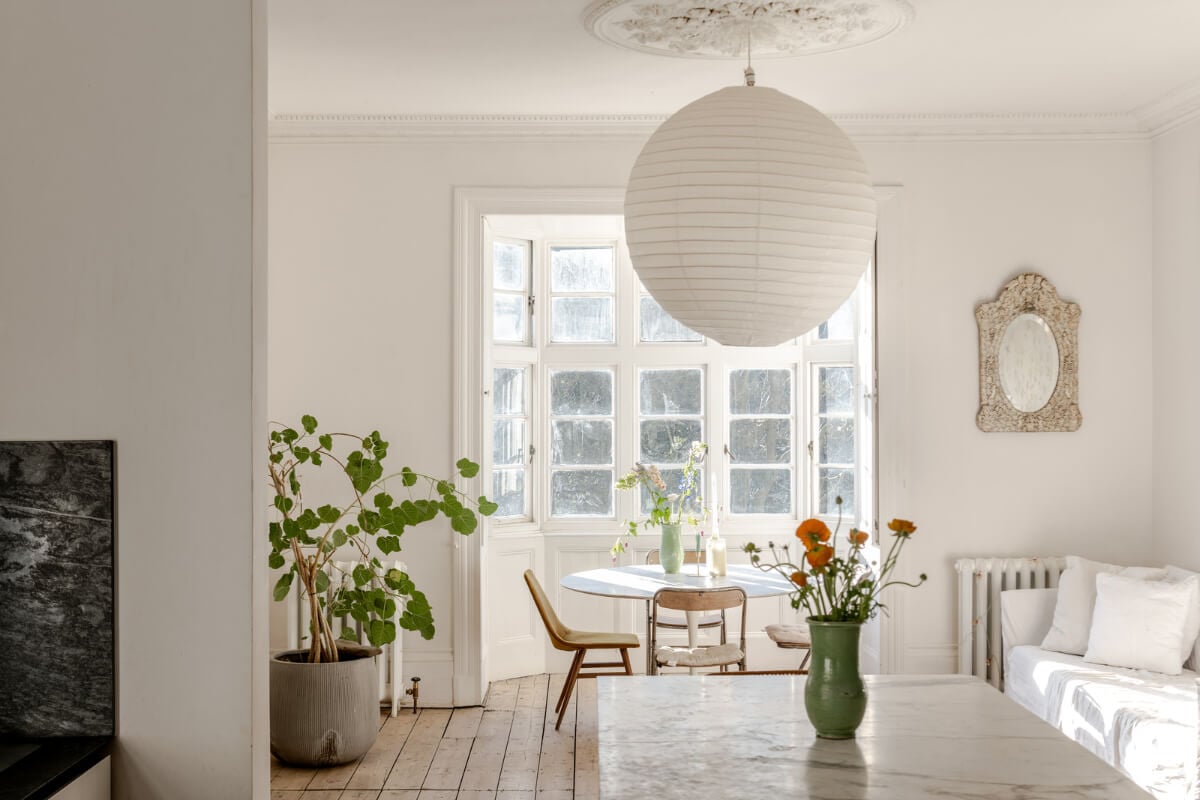 Grand, Light-Filled Spaces in a Gothic-Style English Coastal Home 11 kitchen dining table bay window