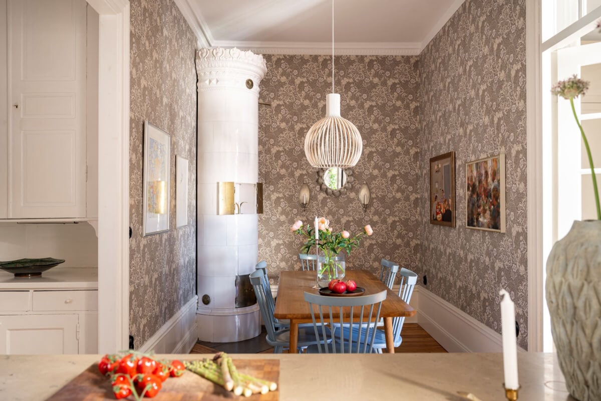 Wallpapers and Blue Tones in a Cozy Turn-of-the-Century Home 13 kitchen dining table blue chairs fireplace