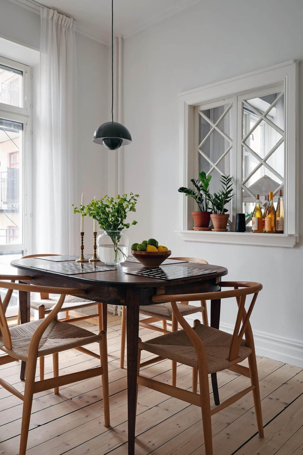 Classic Elements in a Charming Swedish Studio Apartment 17 kitchen dining table with inner window