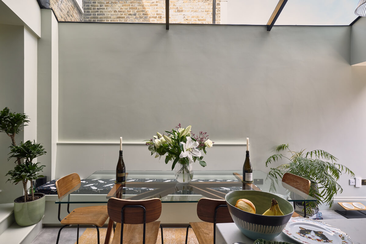 Moody Tones in a Restored and Extended Victorian Home in London 8 kitchen extension skylight dining table built-in bench
