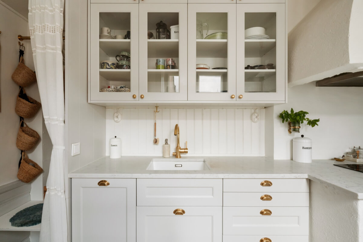 A Charming Attic Apartment in Stockholm's Gamla Stan 10 kitchen marble countertop brass fittings