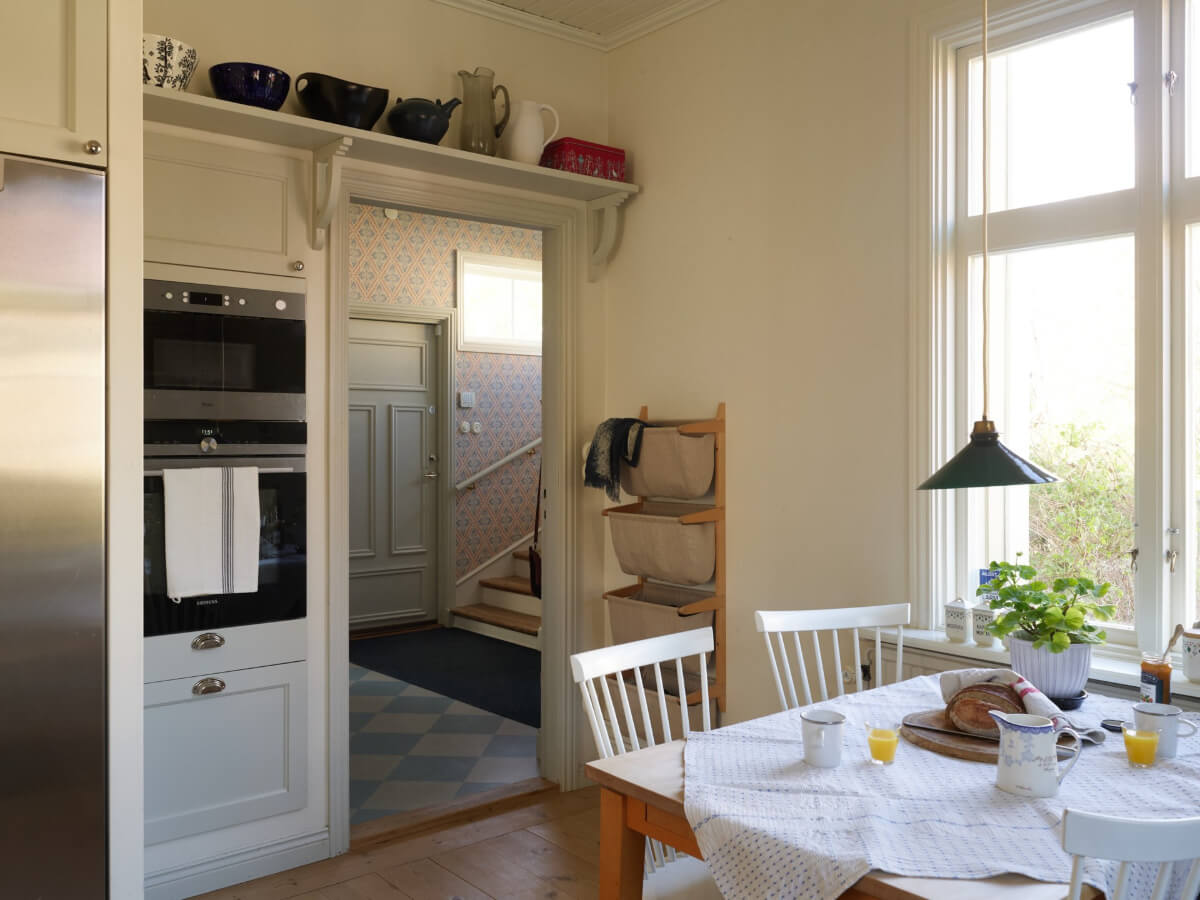 Light-Filled Rooms and Wallpapers in a Swedish Country House 12 kitchen table view into hall checkerboard floor